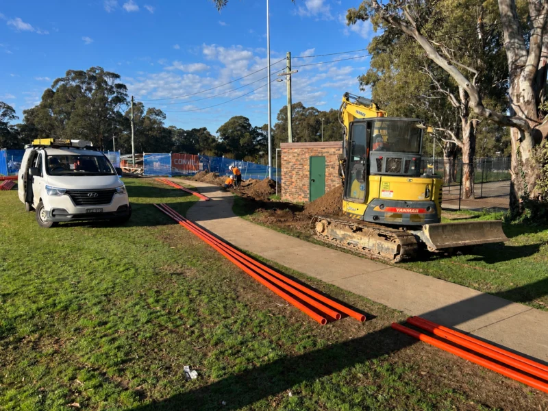 Trenching for underground electrical cabling, with an excavator on site